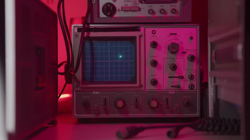 A vintage piece of machinery has a dot moving across the screen