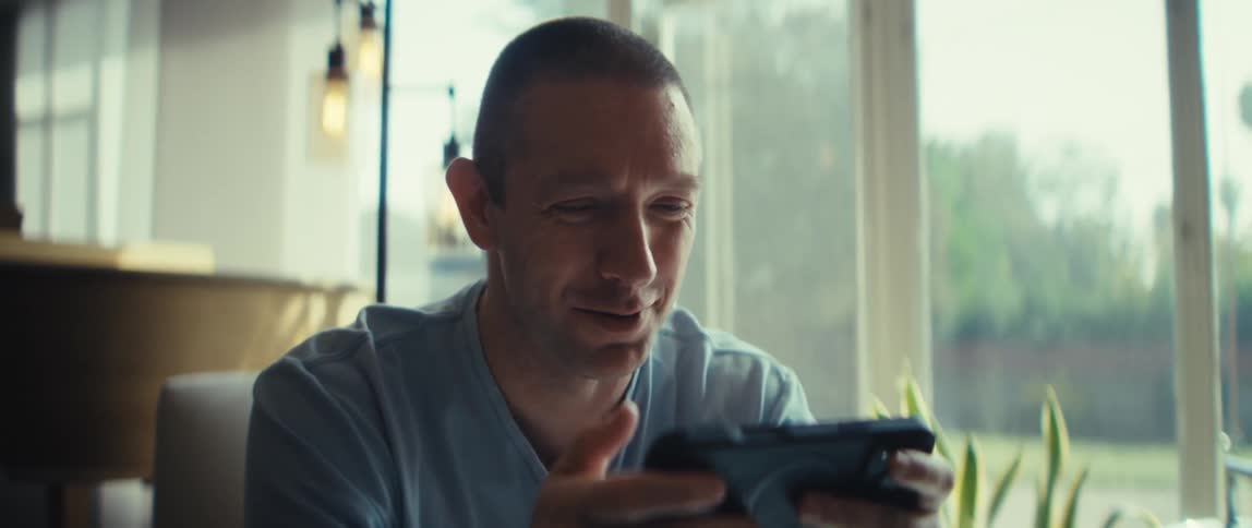 The man smiles and talks on a video call