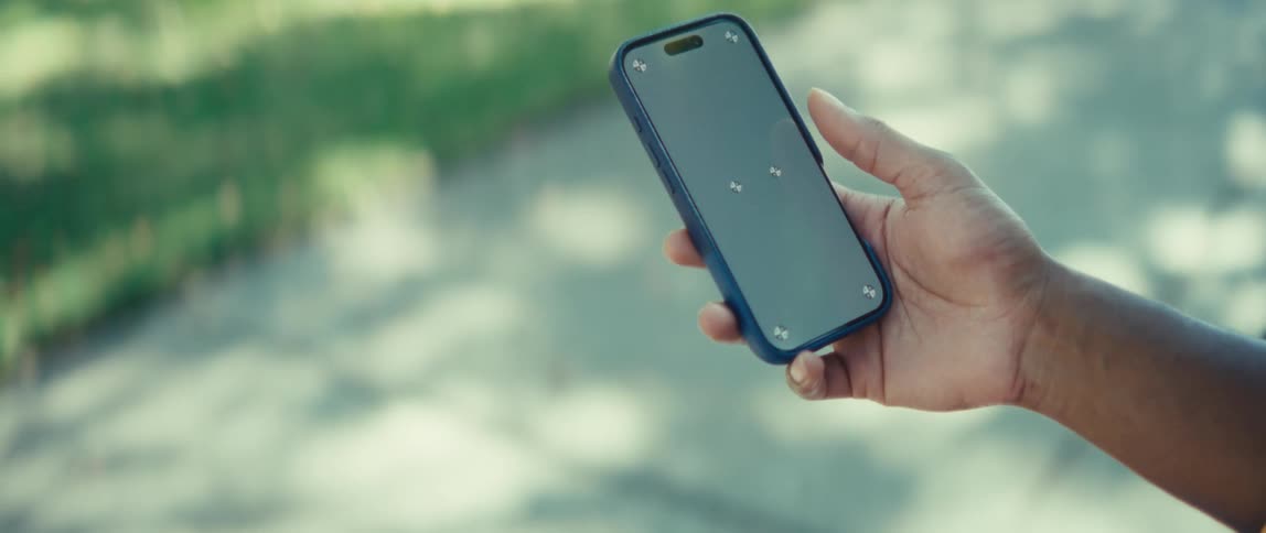 Man holding a cell phone with marks on the screen