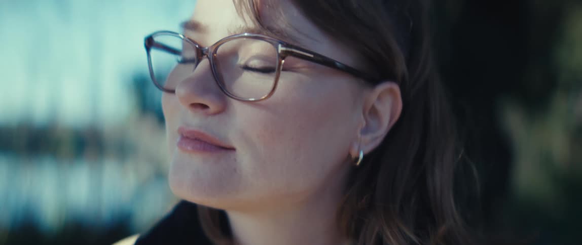The woman is smiling outside