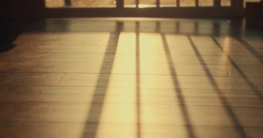 The sun is rising on the beach house
