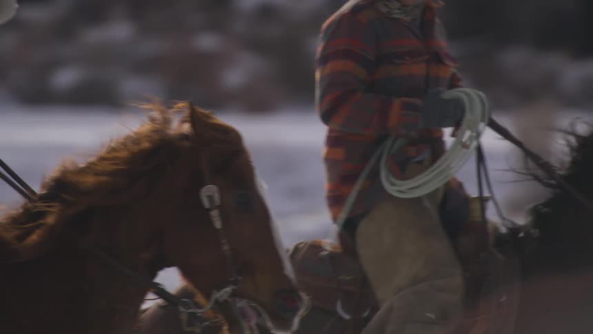 The man and woman race on horses