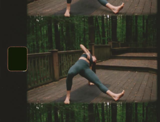 Person practices stretching on a wooden deck surrounded by forest