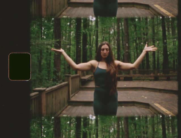 A cellphone is playing a fitness video showing yoga poses