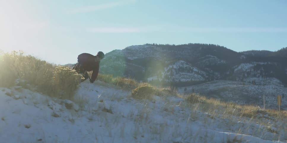 The man rides downhill on his mountain bike