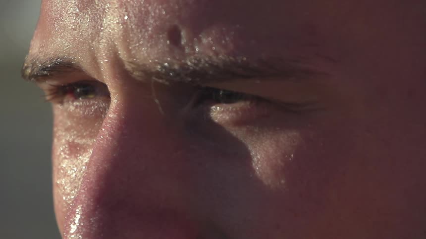 A man is sweating as she stares forward