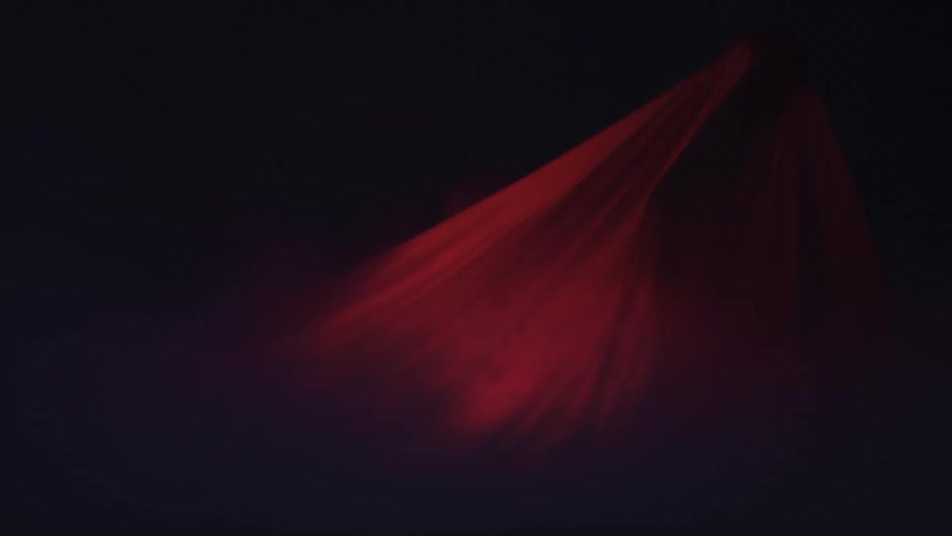 A dark scene shows swirling red smoke and light fabric forming soft arcing streaks of light against a black background