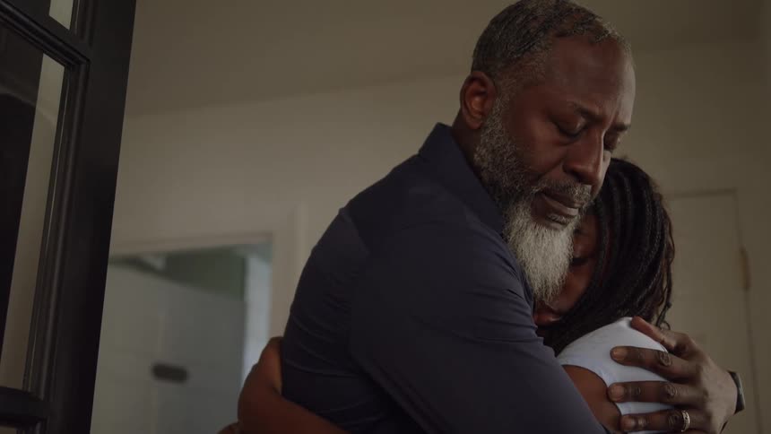 Father and daughter share a heartfelt hug indoors