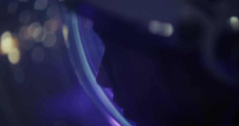Colorful reflection lights up the visor of a space helmet in a blue tone