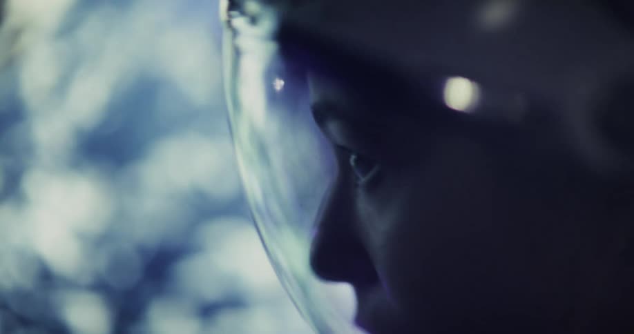 Astronaut looks attentively through the helmet visor