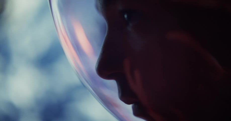 Close up profile shot of an astronaut with an out of focus planet in the background
