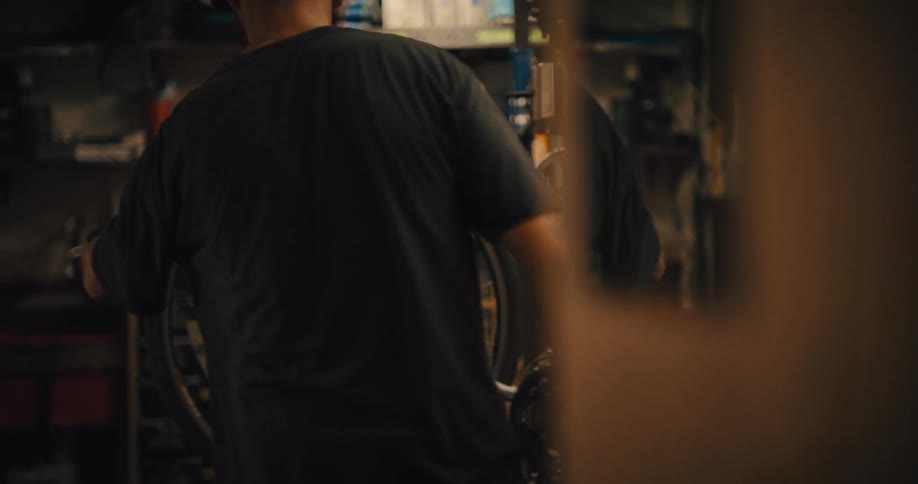 Man works on a bicycle inside a workshop