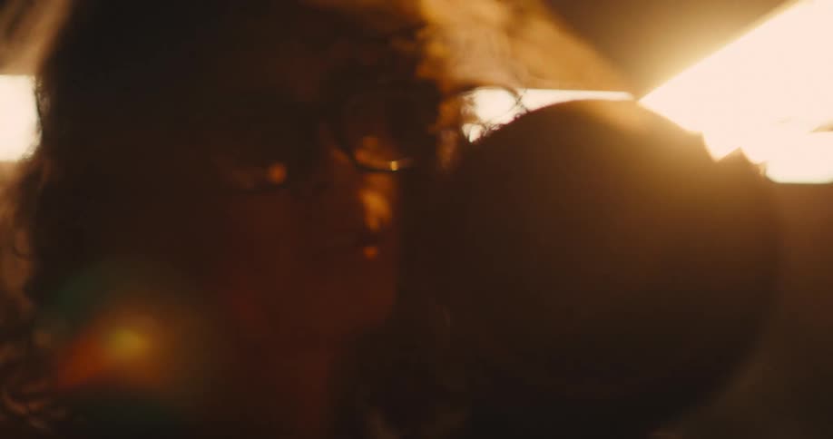 A close up shot of a woman using an angle grinder as sparks fly up into the air