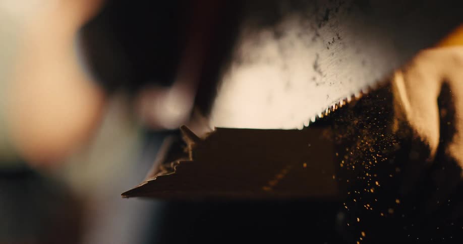A close up of a saw cutting though wood