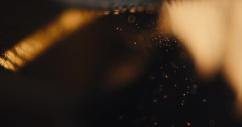 Light illuminates small pieces of sawdust created by a hand saw