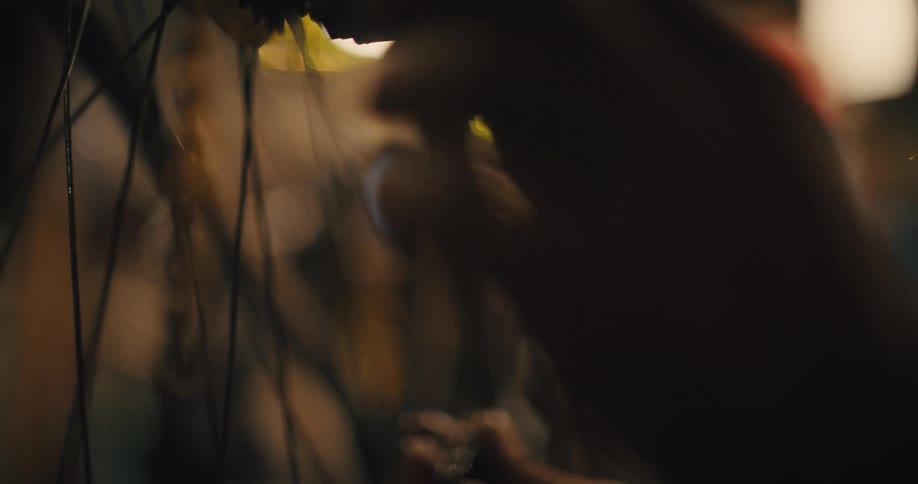 A man is working on the chain of a bicycle