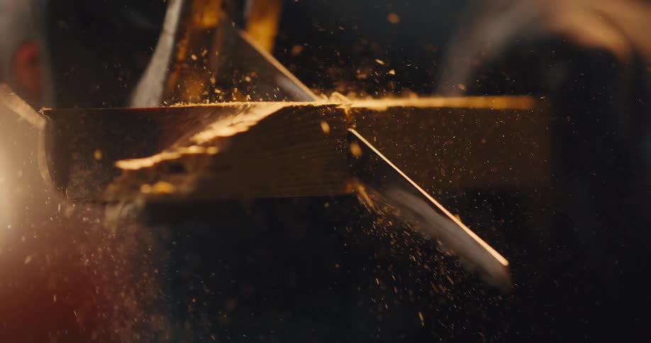 A slow motion  close up of an electric saw cutting through wood