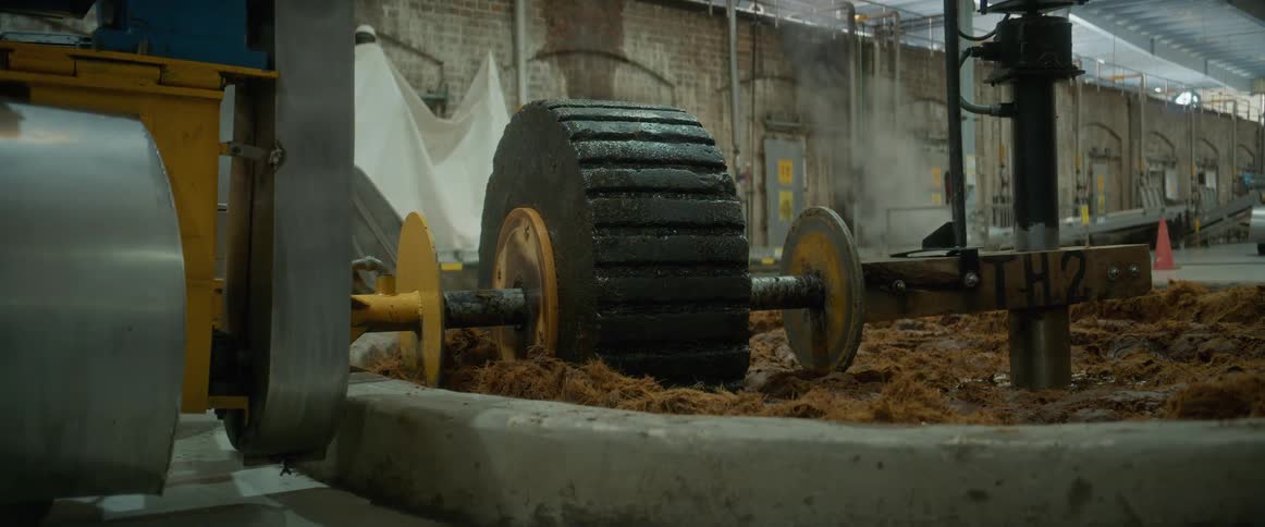 Industrial gear presses wet plant fibers in a processing stage