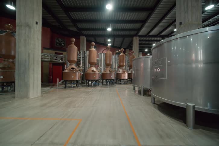 A warehouse factory filled with stainless steel cylinders