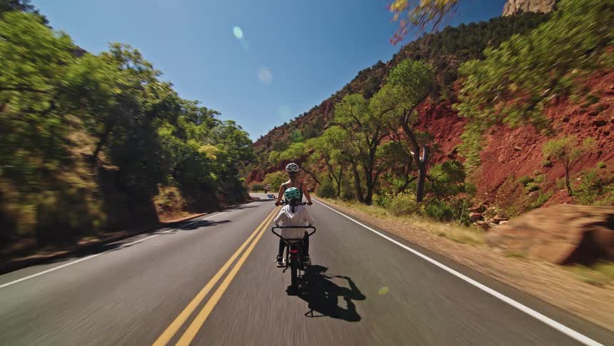 The woman rides with her daughter on an electric bike