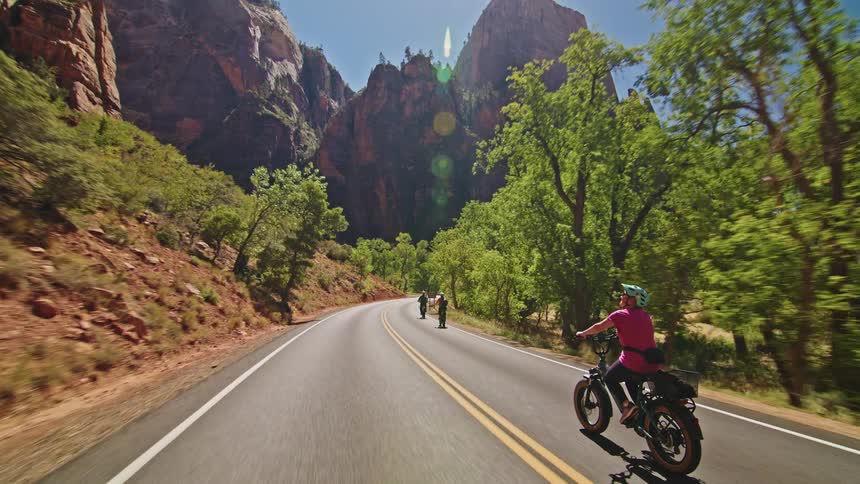 People cycling on a mountain canyon road