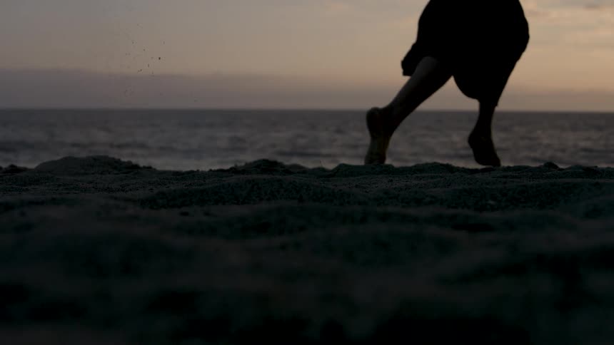 The woman runs in the sand
