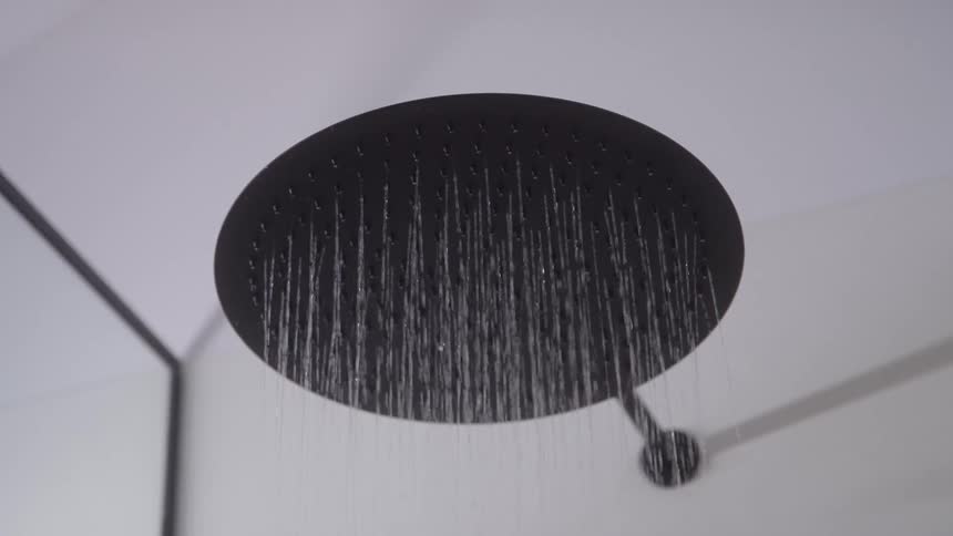 Close up of a running shower faucet in a building