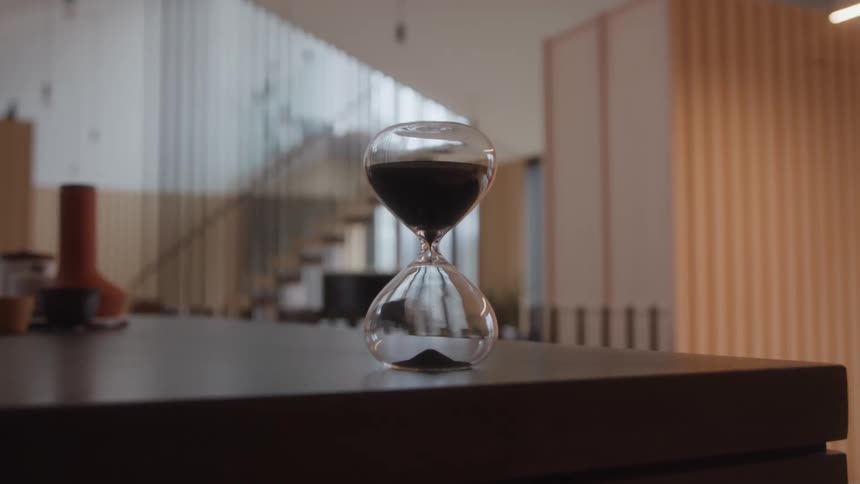 The hourglass slowly pours sand