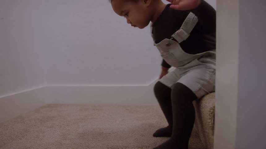 The baby crawls down the stairs