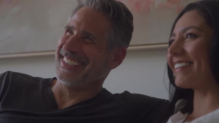 Man and woman smiling side by side in a relaxed moment