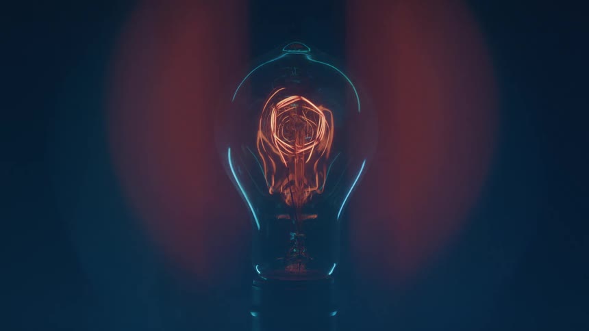 Light bulb with red filament dimming as the light fades slowly