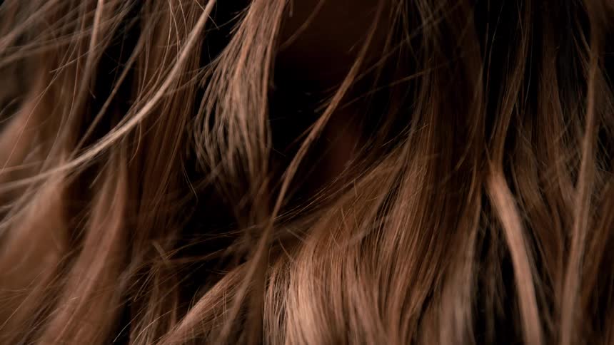 Golden strands intertwining in gentle motion