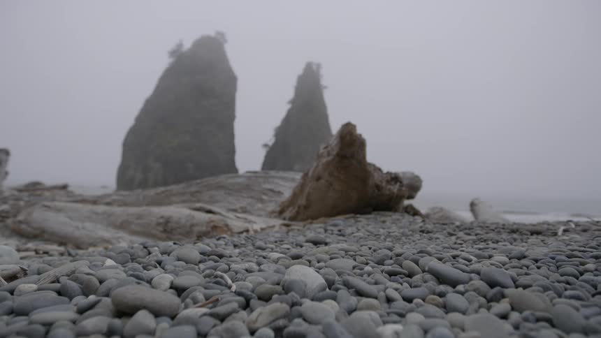 Waves lap a pebble-strewn shoreline