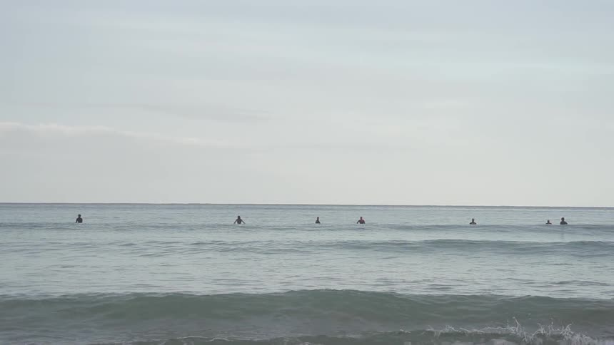 People in the water on a cloudy day