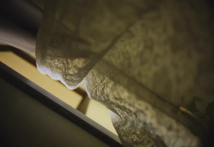 Lace curtain lit by soft light reveals delicate and shadowed texture