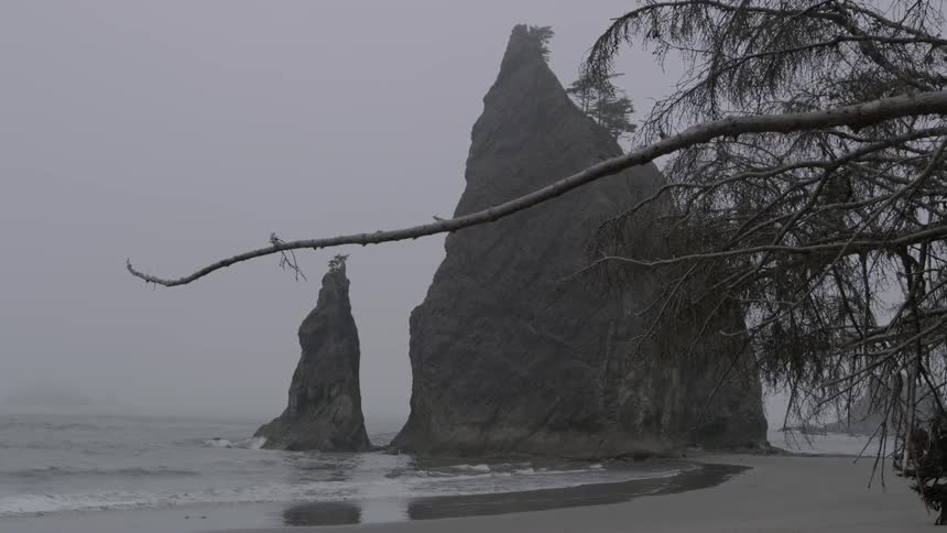 Large rock formations are near the shore