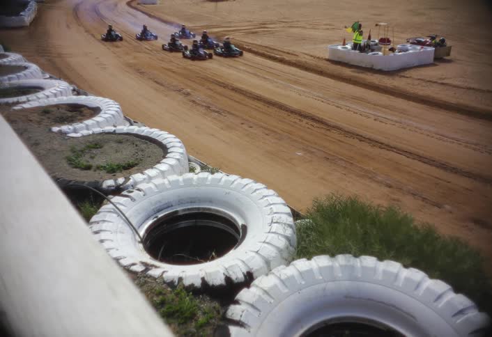 Go karts speed by on the track