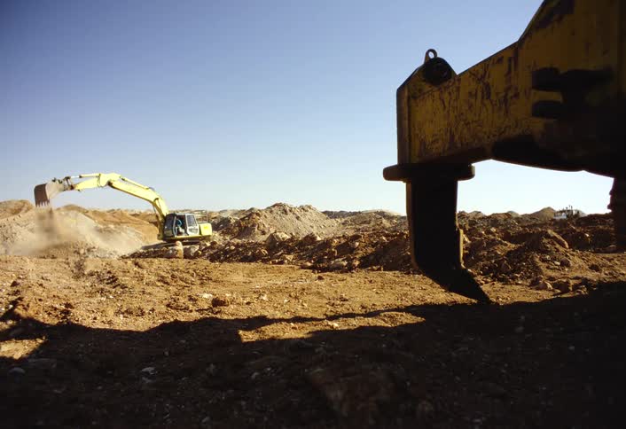 The excavator is digging on the field