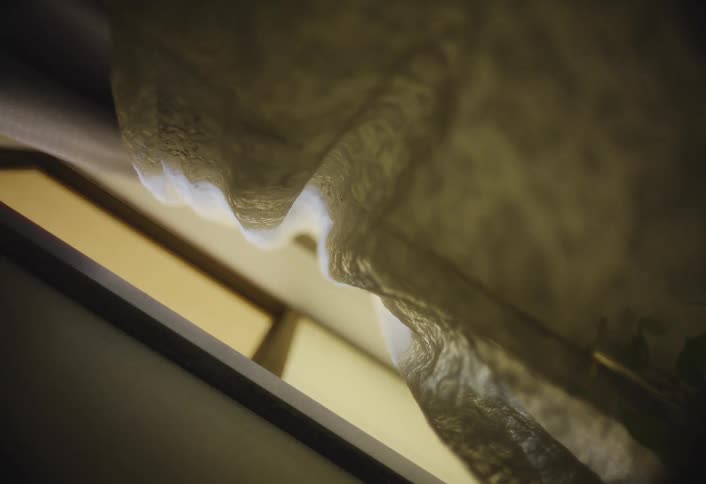Curtains sway gently in the wind as sunlight streams through a window
