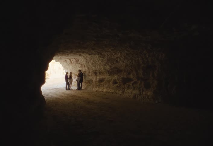The people are talking in the cave