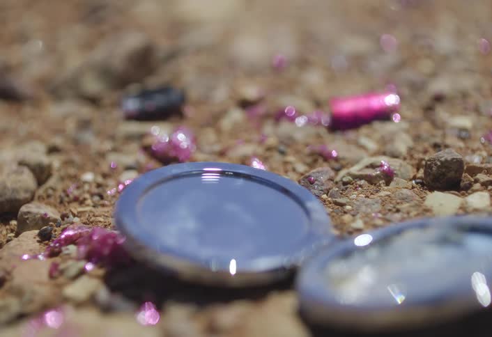 Spilled makeup and a compact mirror lay on the ground