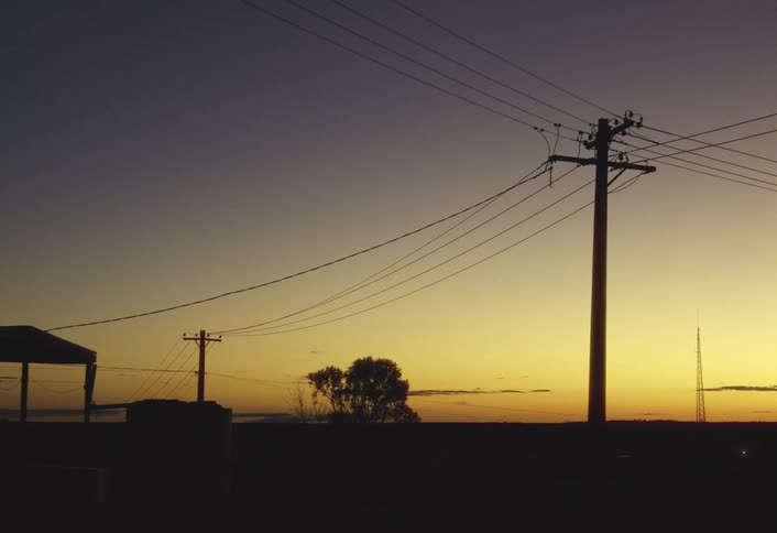 Utility wires stretch across the landscape