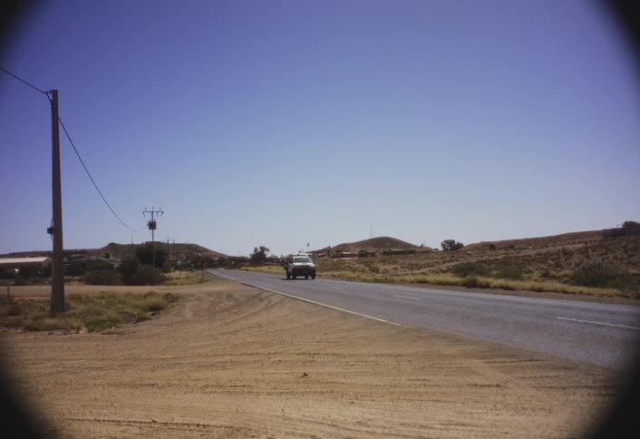 The truck drives on the road on a sunny day