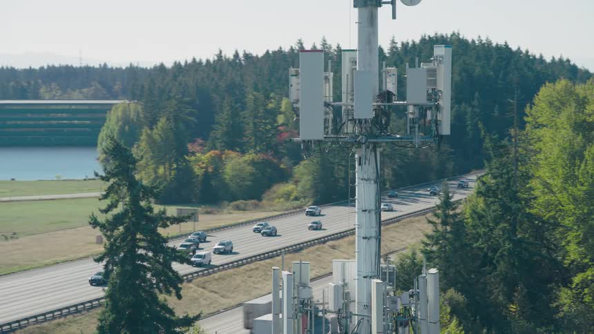Reveal of a busy interstate highway and office park within the coverage area of a next gen cell site