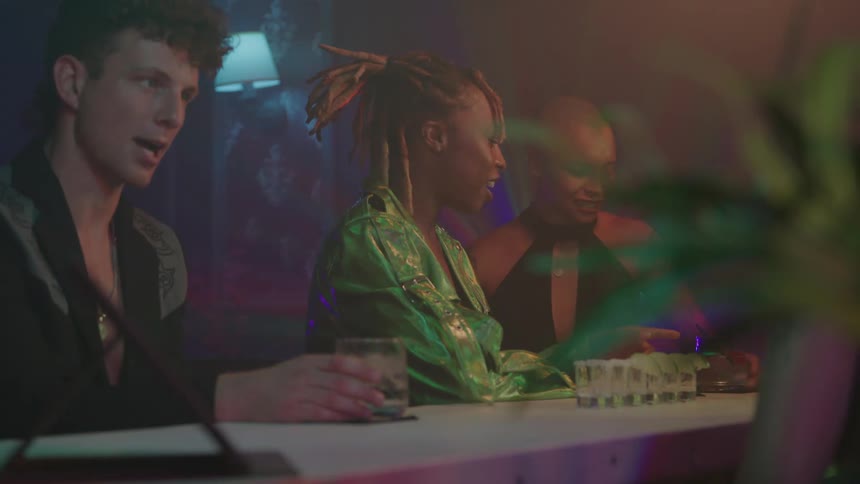 People enjoy themselves while sitting at the bar in a smoky room