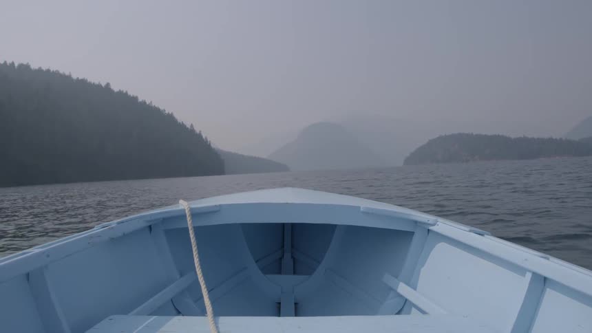 A boat's prow bobs on the waves