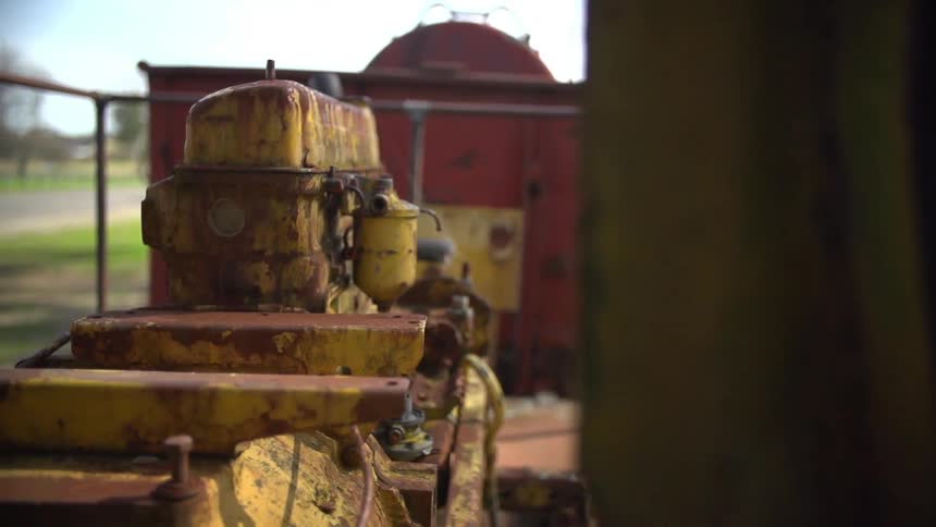 A yellow machine in a fenced in area