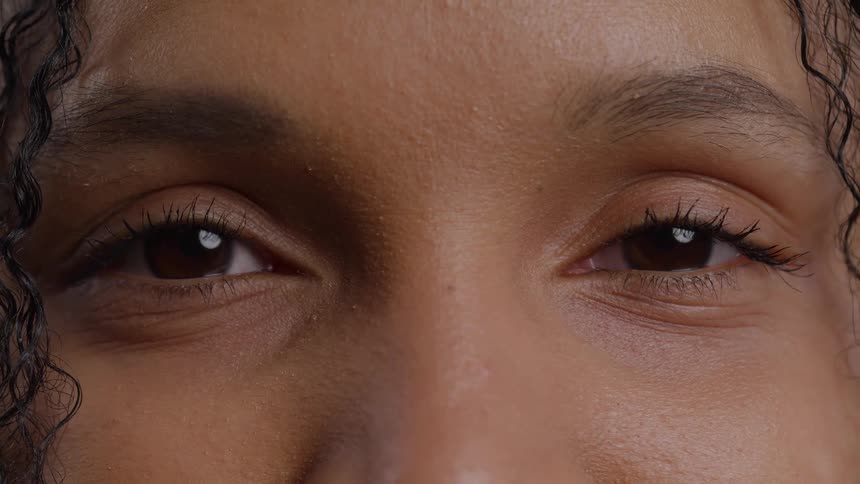 Woman opens her smiling eyes and stares