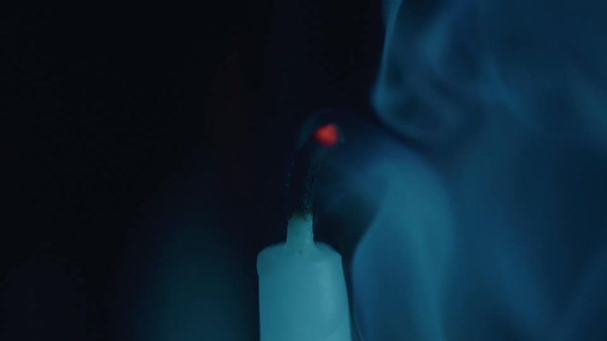The candle is blown out and smoke rises