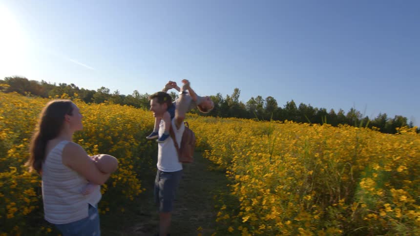 A portrait of a family outdoors on a sunny day